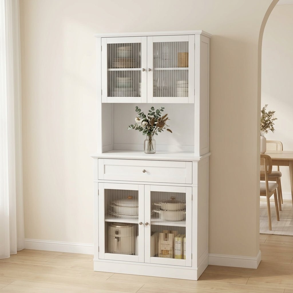 Freestanding white kitchen pantry cabinet with fluted glass doors, central drawer, and open shelves by Kouvr.