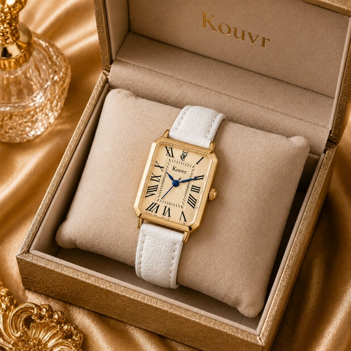 Kouvr white leather women's watch displayed inside a luxury gold velvet presentation box.
