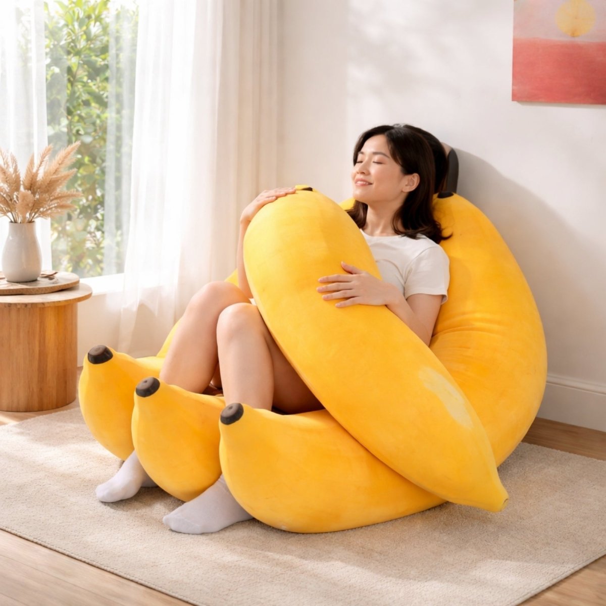 Model sitting in oversized yellow banana plush chair hugging the memory foam peel armrests for sensory comfort.