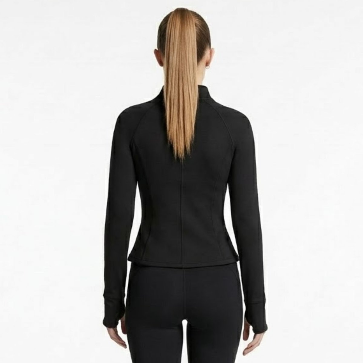 Back view of woman modeling black long sleeve sculpted athletic track jacket with contoured seaming by Kouvr.