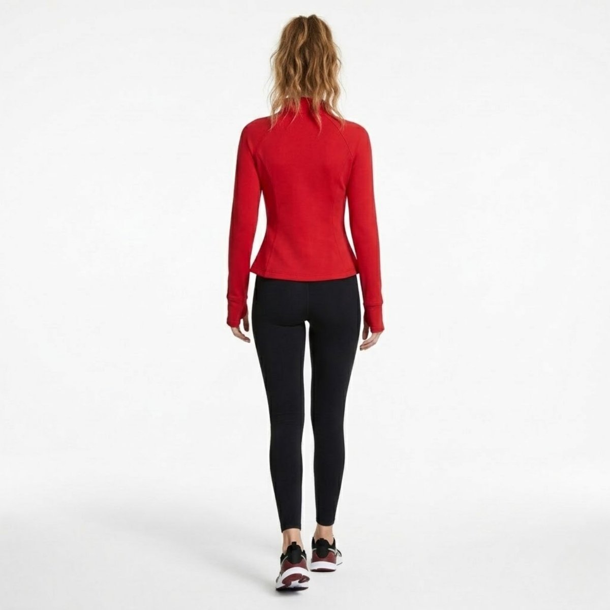 Full body back view of model wearing red athletic jacket and black workout leggings with sneakers