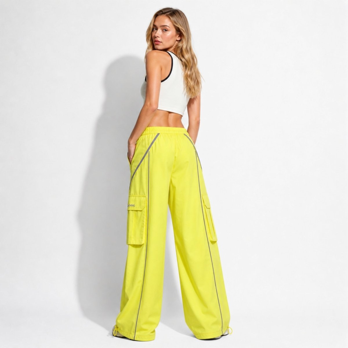 Full back view of neon yellow baggy streetwear pants with adjustable bungee ankle hems