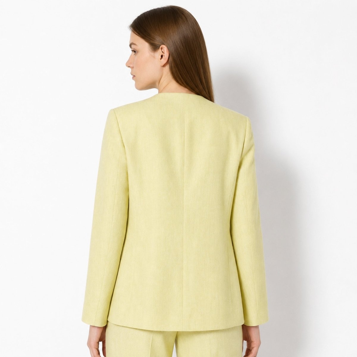 Back view of woman wearing Kouvr tailored yellow single button suit jacket.