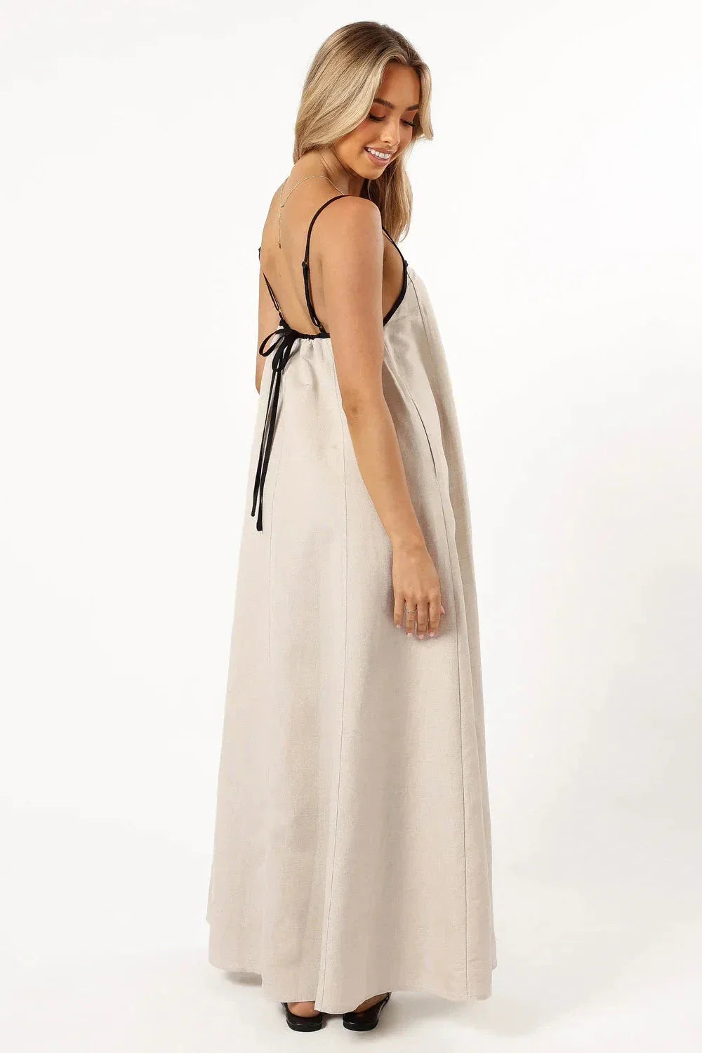 Model wearing Kouvr Akisha natural linen maxi dress with open back tie
