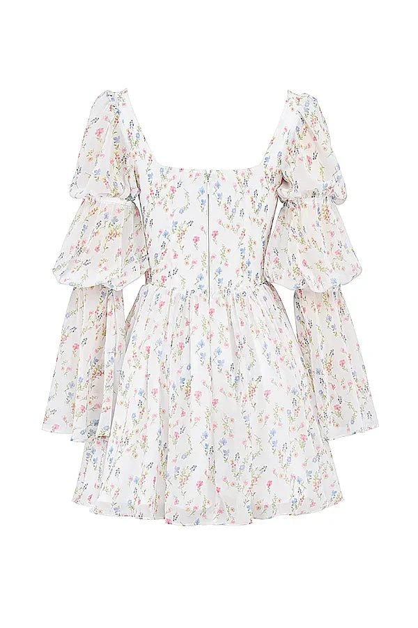 Model wearing the Kouvr Fashion white floral puff sleeve mini dress
