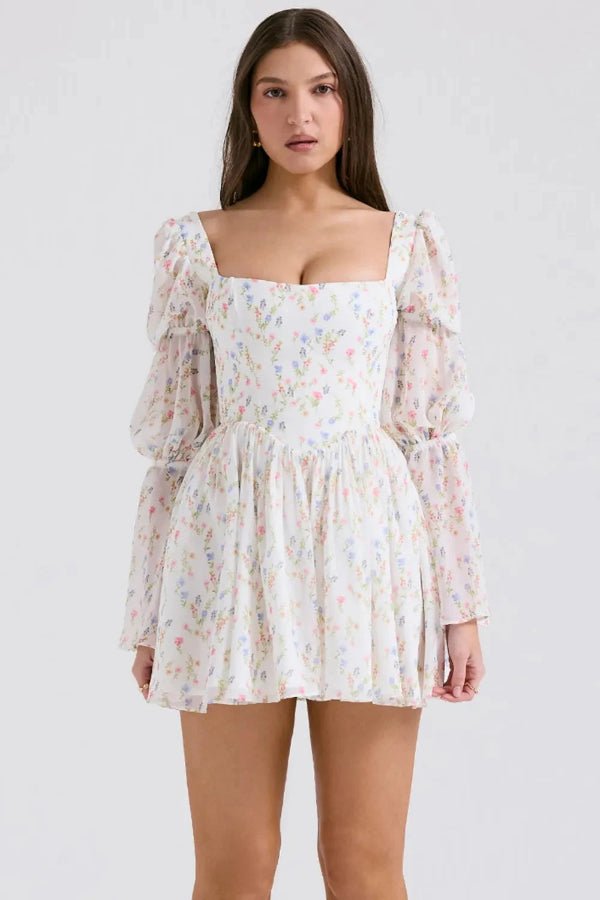 Model wearing the Kouvr Fashion white floral puff sleeve mini dress