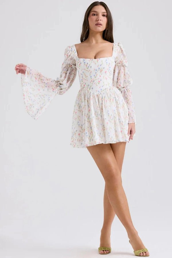 Model wearing the Kouvr Fashion white floral puff sleeve mini dress