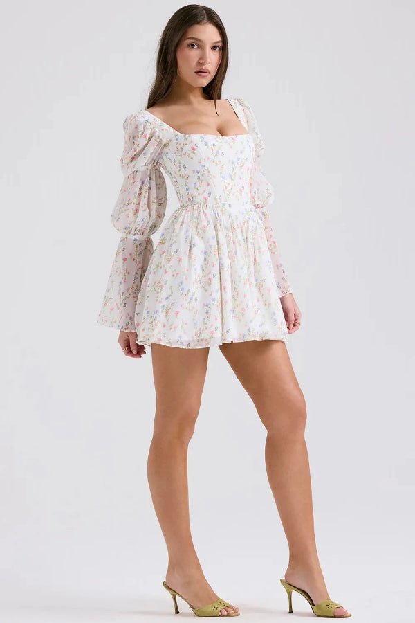 Model wearing the Kouvr Fashion white floral puff sleeve mini dress