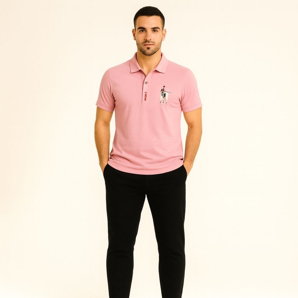 Man wearing the Kouvr slim fit Rose Quartz pink polo shirt with black trousers against a white background.