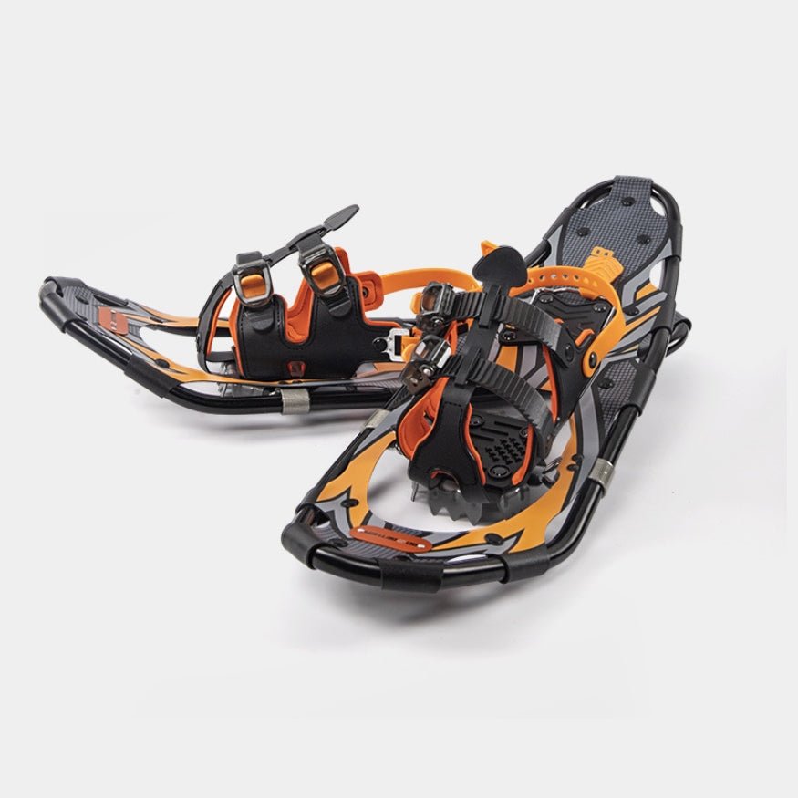Detail view of orange and black snowshoes showing the adjustable boot bindings and durable frame.