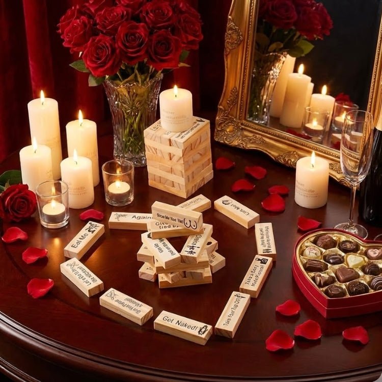 Flat lay of a 48-piece naughty adult game set surrounded by a bouquet of red roses, lit candles, and a heart-shaped box of chocolates for Valentine's Day.