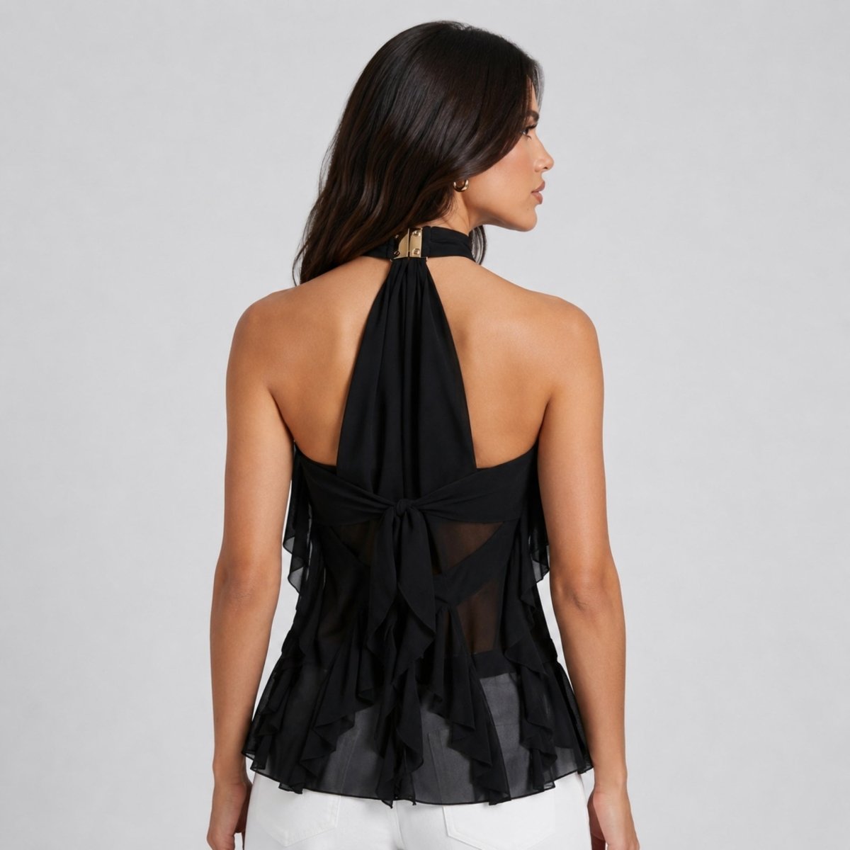  Back view of model wearing Kouvr black sleeveless evening top showcasing an elegant open back design with a self-tie chiffon bow.