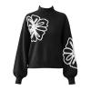 Product-only image of the Kouvr Cynthia black sweater laid flat, displaying the front design with embroidered flowers on the chest and sleeve.