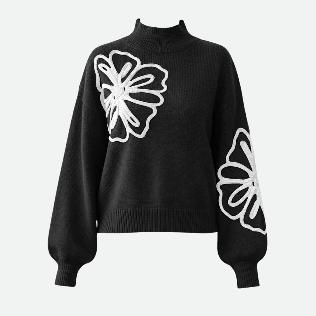 Product-only image of the Kouvr Cynthia black sweater laid flat, displaying the front design with embroidered flowers on the chest and sleeve.