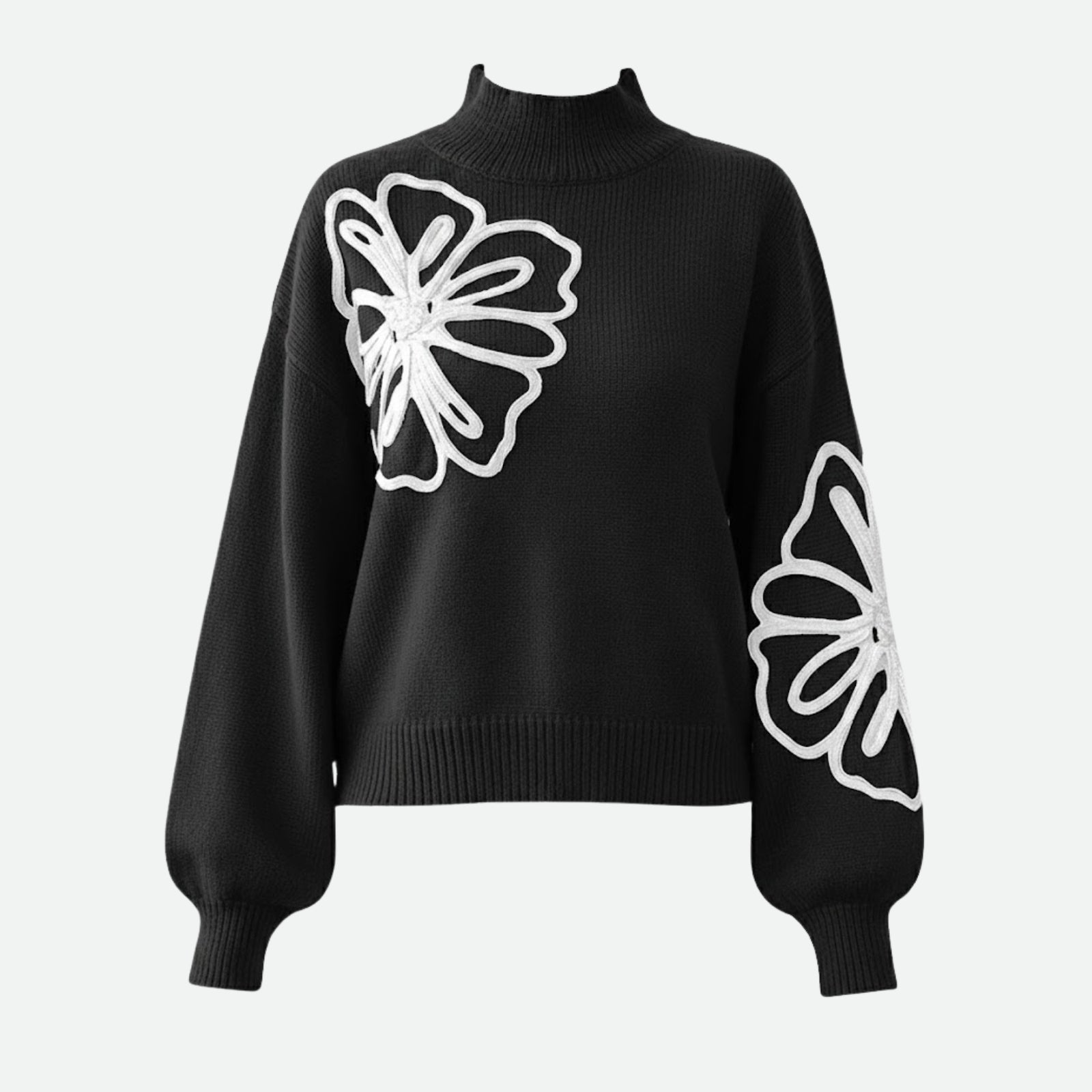 Product-only image of the Kouvr Cynthia black sweater laid flat, displaying the front design with embroidered flowers on the chest and sleeve.
