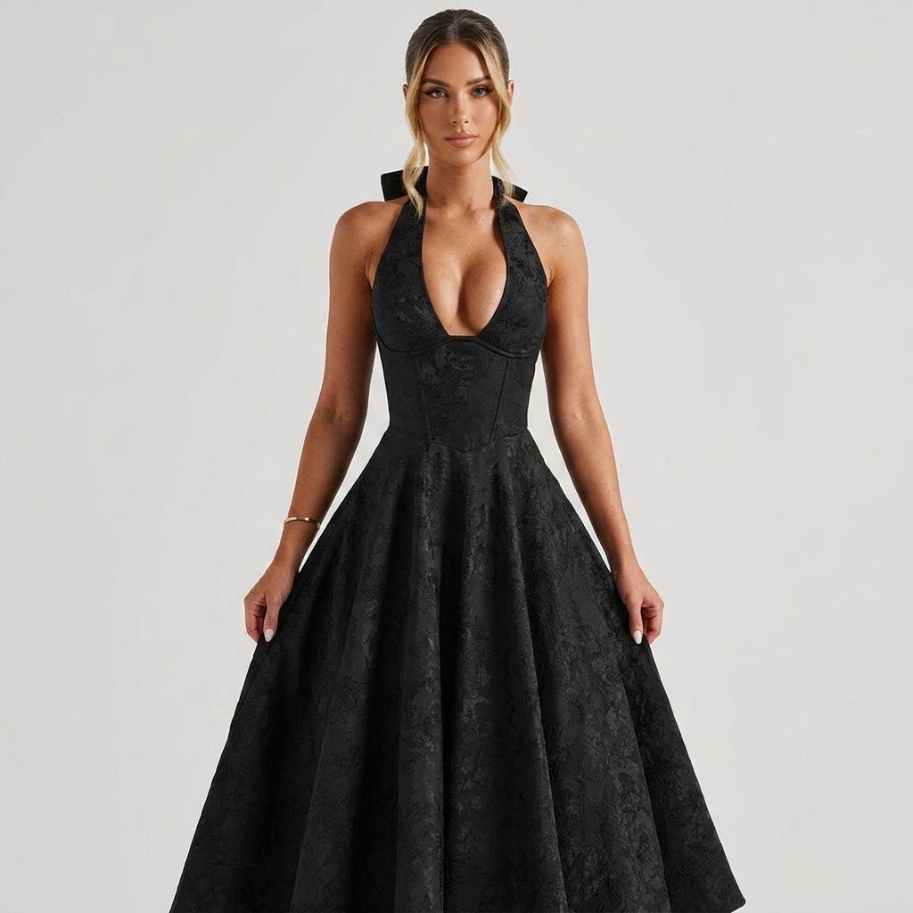 Close up of black brocade structured corset bodice with deep V-neckline on formal cocktail dress.
