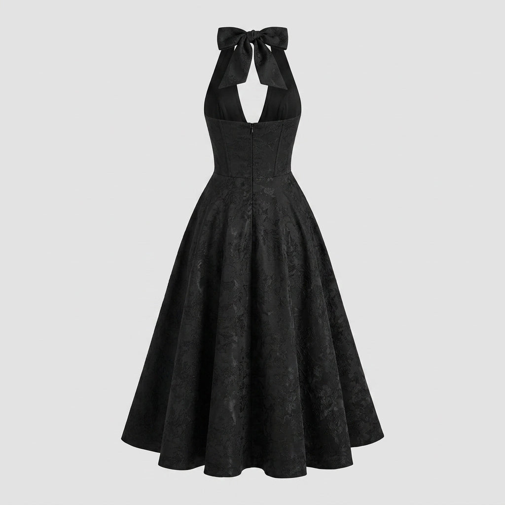 Back view of black formal midi dress showing invisible zipper and self-tie neck bow.