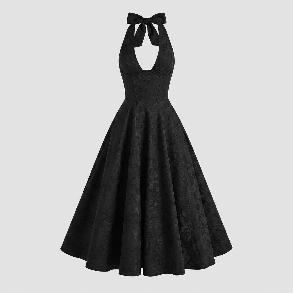 Front view of black A-line midi dress with halter neck and subtle floral woven pattern on white background.