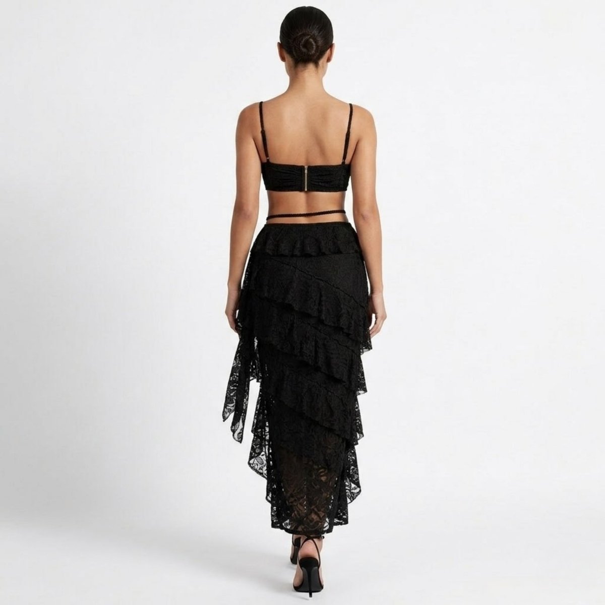 Back view of black lace co-ord showing exposed gold zipper on top and cascading sheer lace skirt layers