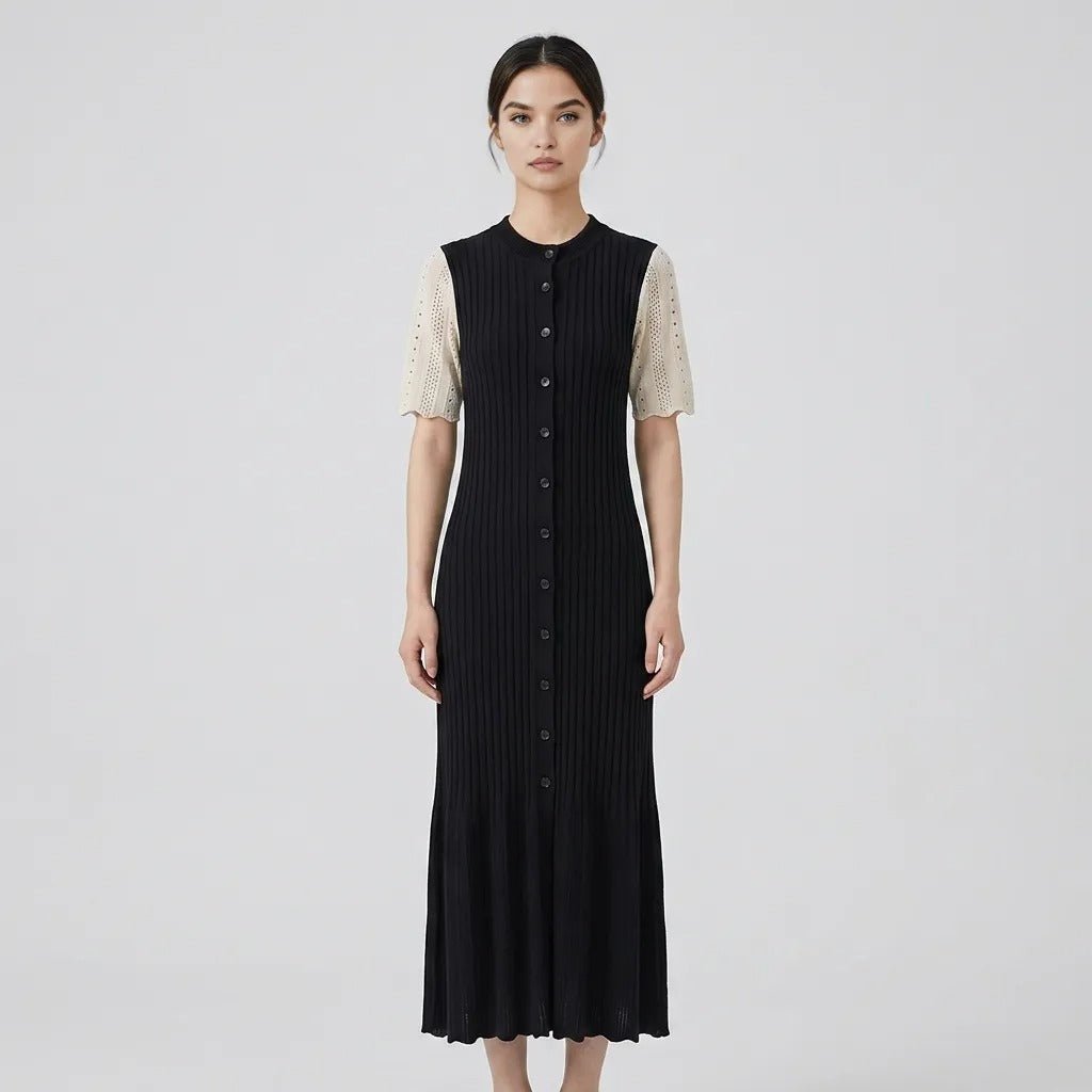 Front view of female model wearing the Kouvr black ribbed knit button-down maxi dress with contrasting cream pointelle short sleeves.