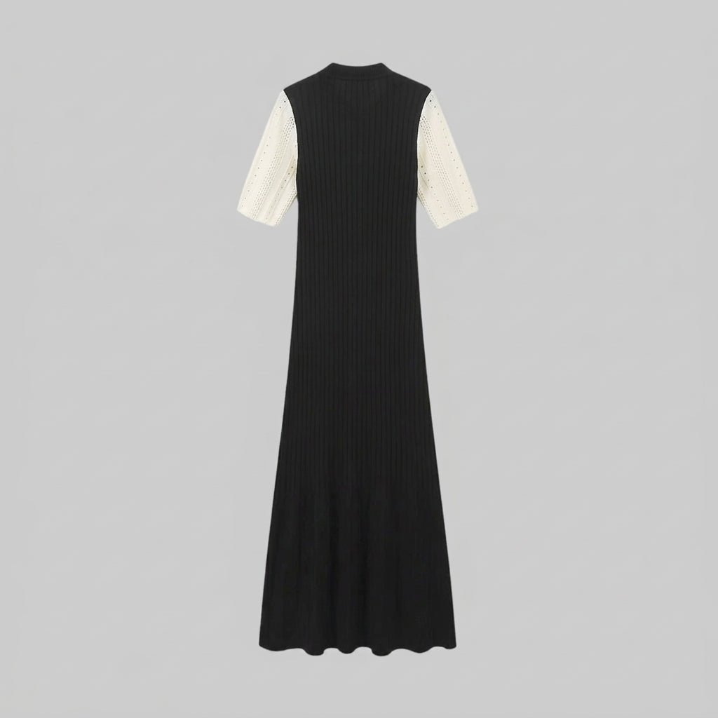 Flat lay back view of the Kouvr black ribbed knit maxi dress showing the stretch ribbed fabric texture and contrasting sleeves.
