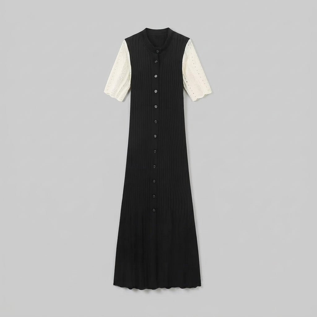  Flat lay front view of the Kouvr black ribbed knit button-down maxi dress with cream short sleeves on a grey background.