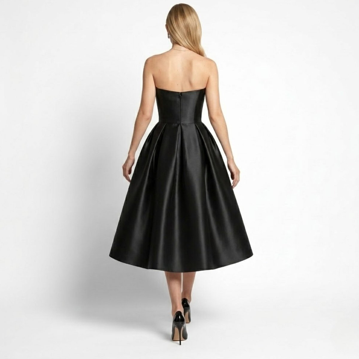 Back view of black satin strapless formal midi dress showing hidden zipper closure and flared skirt by Kouvr