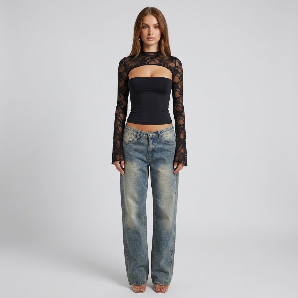 Full body look of a model wearing an elegant black lace long sleeve cutout top paired with vintage wash straight leg denim jeans.