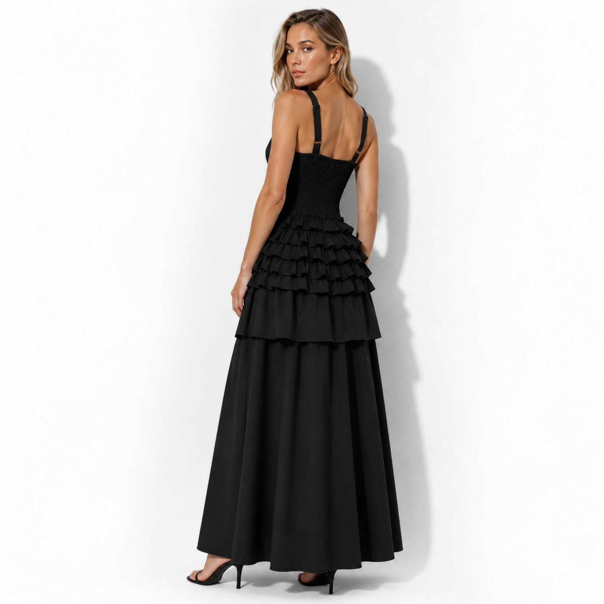 Back view highlighting the engineered smocked bodice and adjustable hardware straps on Kouvr black elegant a-line midi dress.