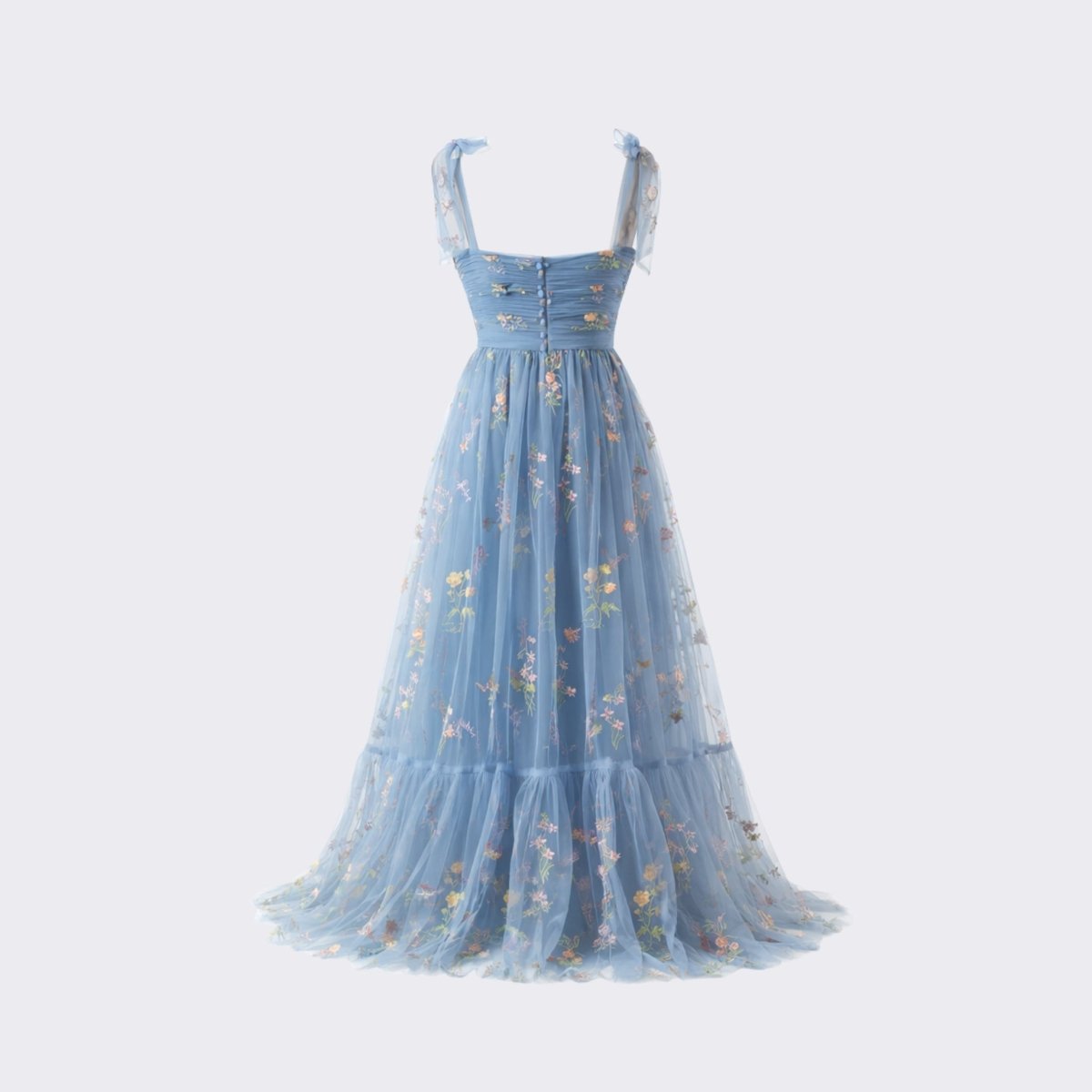 Studio flat lay back view of the Kouvr blue floral tulle dress detailing the elegant button back closure and lightweight mesh floral overlay.