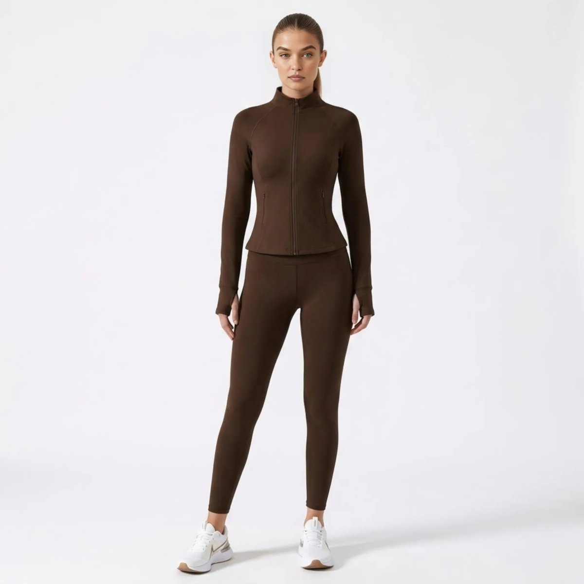 Full body lifestyle view of chocolate brown activewear jacket and matching leggings