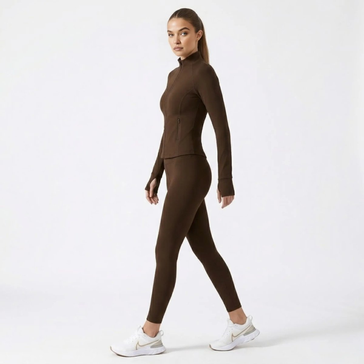 Side profile of woman walking in  brown mock neck workout jacket