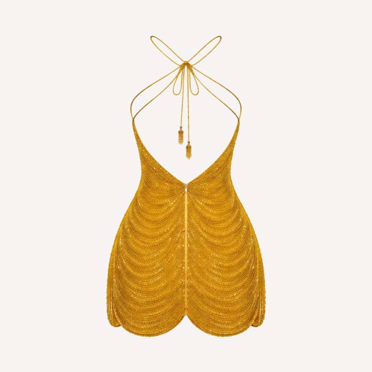 Flat lay product image of the back of the Carey gold beaded mini dress, showing the backless design and tassel ties.