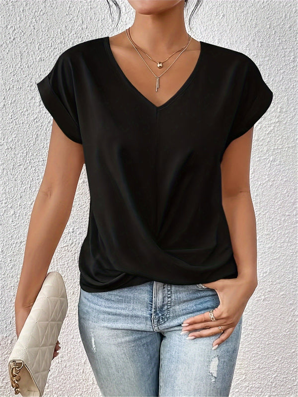 Person wearing a black top and blue jeans against a light gray background