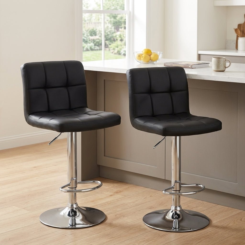 Couple sitting comfortably on black modern swivel bar stools engaged in conversation at a minimalist wood kitchen counter.