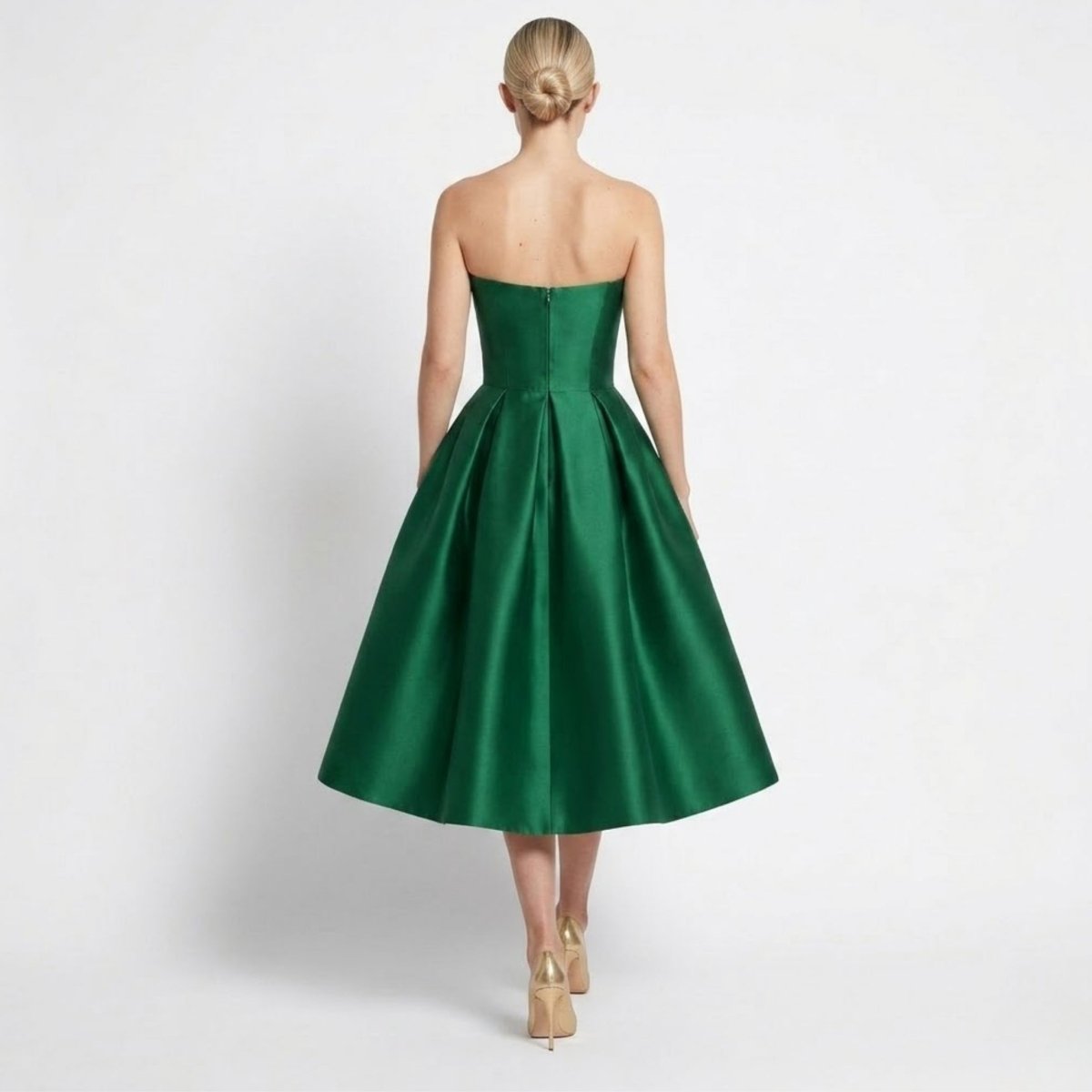 Back view of the dark green satin evening dress highlighting the invisible zipper closure and structured flared midi hem.