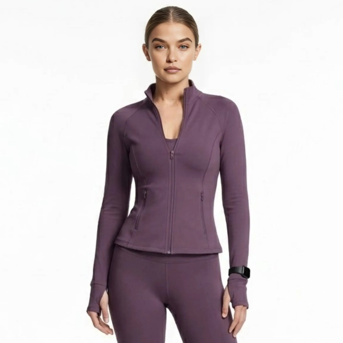 Woman wearing Kouvr dark purple form-fitting zip-up activewear track jacket with thumbholes front view