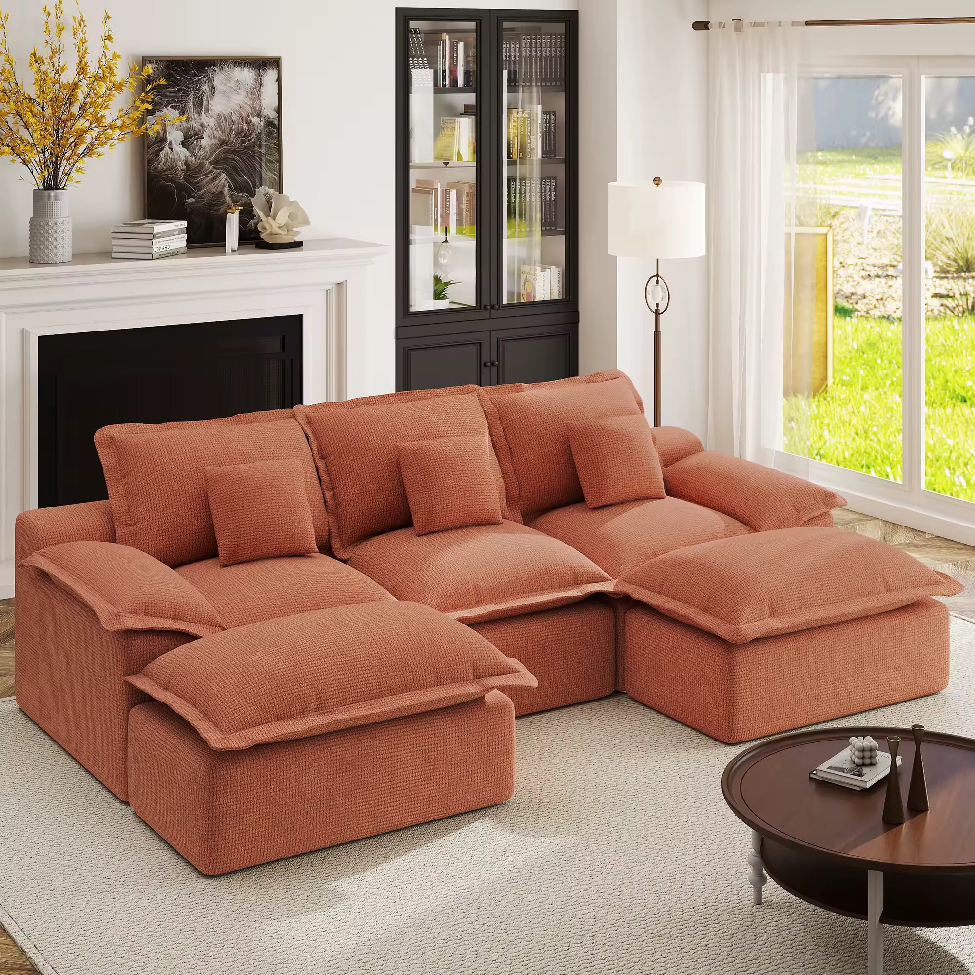 Earthy orange sectional couch in a moody, dark-walled living room with minimalist gold accents and warm lighting.