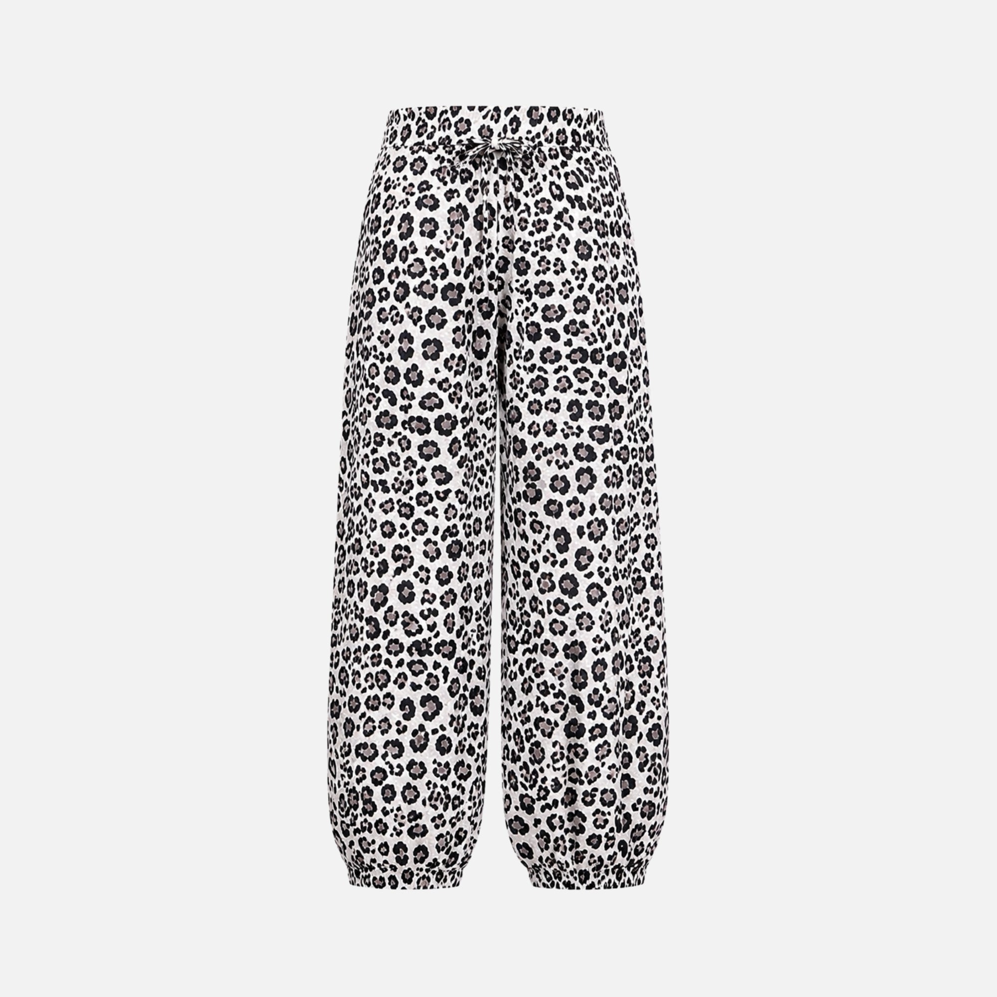 Flat lay detail of elastic waist animal print pants revealing the adjustable drawstring and gathered waistband construction