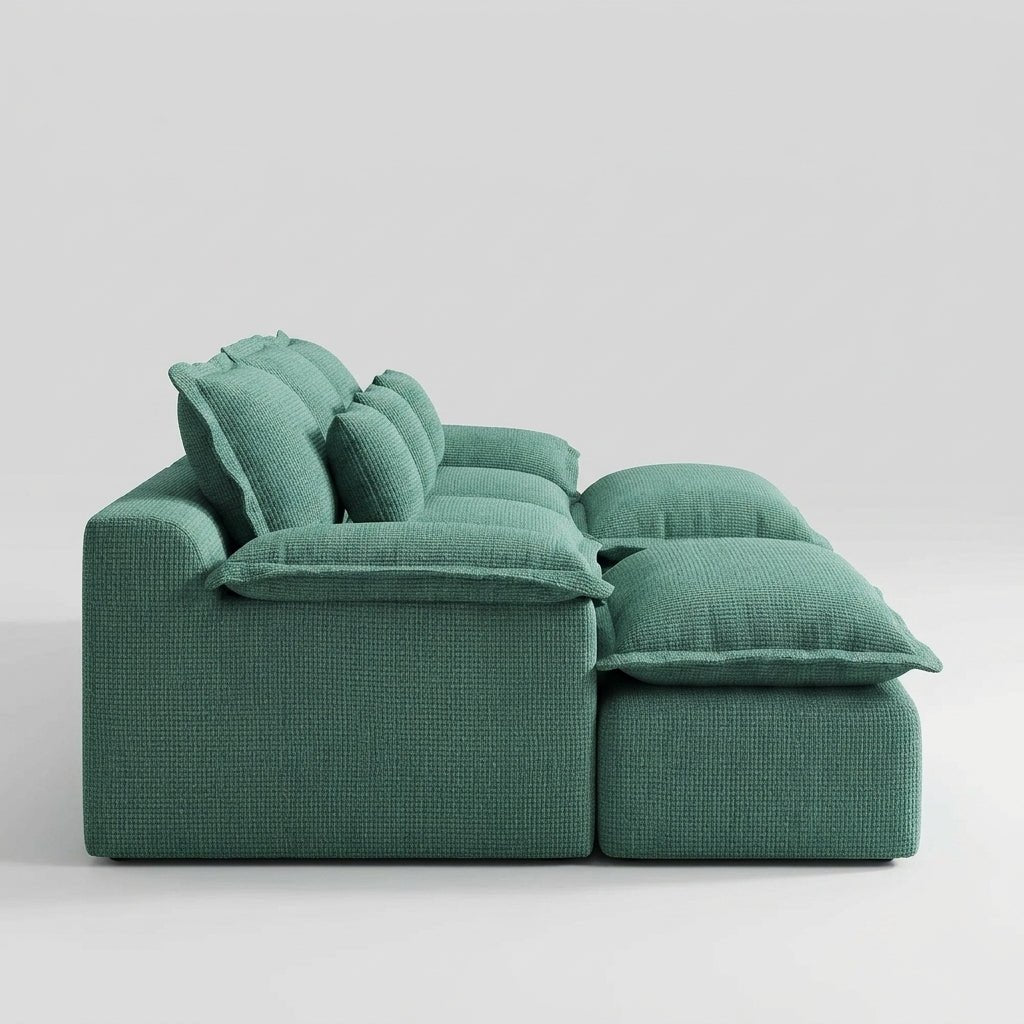 Front view of a forest green U-shaped modular sectional sofa in a moody, dark minimalist living room.
