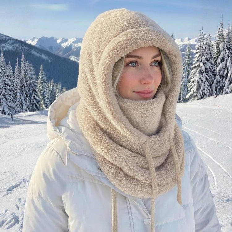 Side profile of beige fuzzy ski mask hood protecting face from cold wind.