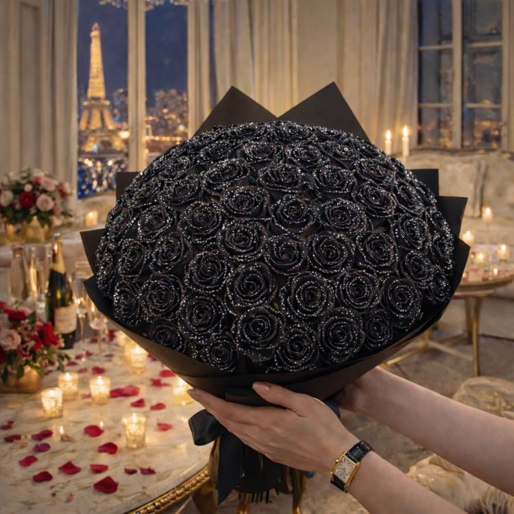 A huge, spherical bouquet of black sparkle roses held by a woman. A bold and elegant statement gift featuring handmade eternal flowers covered in black glitter.