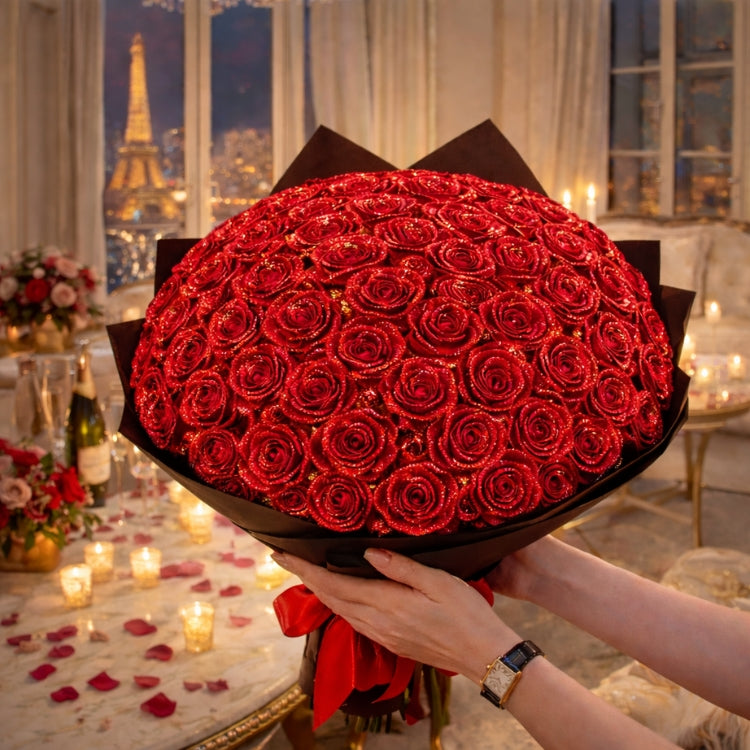 An enormous bouquet of red sparkle roses held in front of the Eiffel Tower at night. The perfect oversized luxury flower arrangement for marriage proposals.