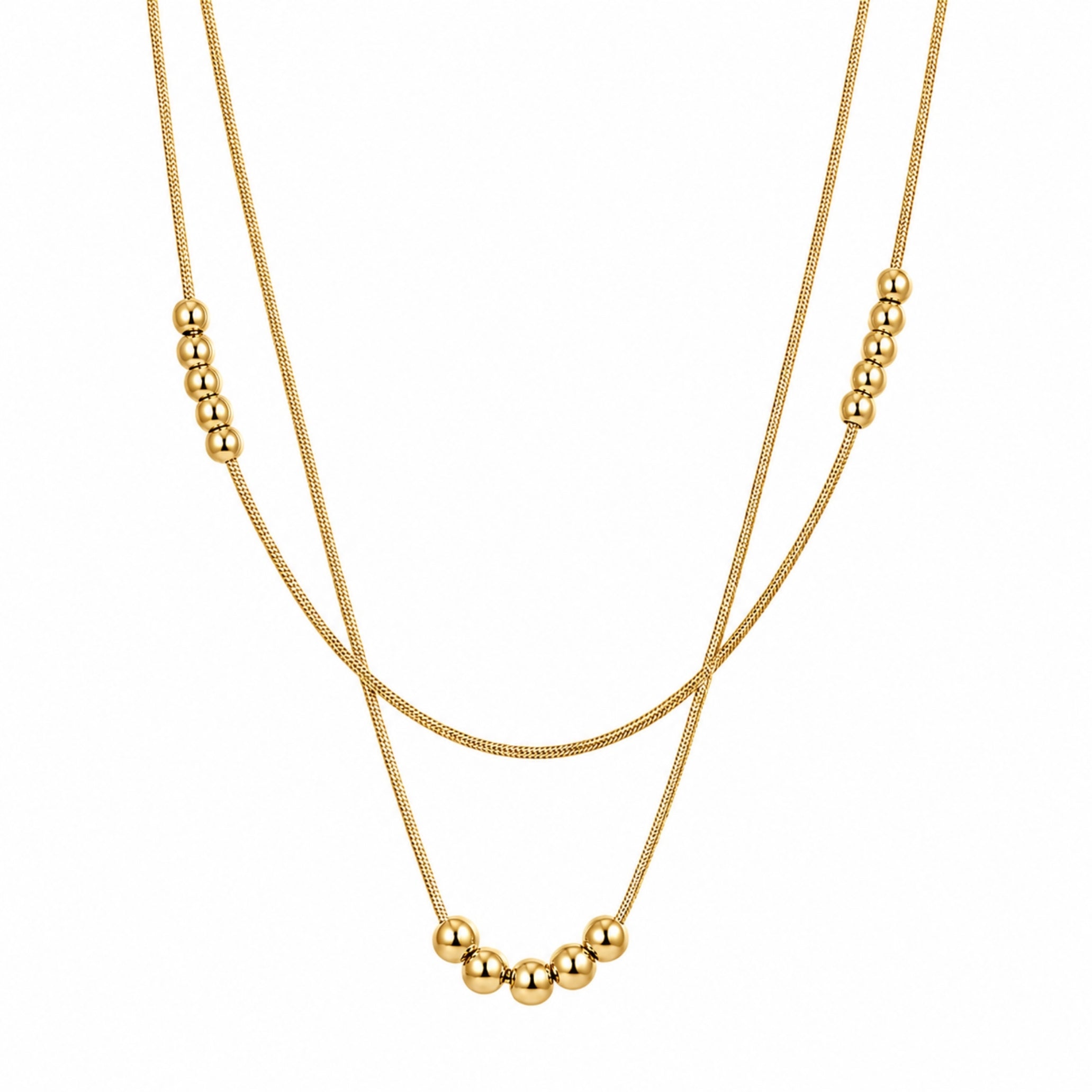 Close up of minimalist double layered snake chain necklace in polished gold featuring 4mm and 5mm metal bead accents.