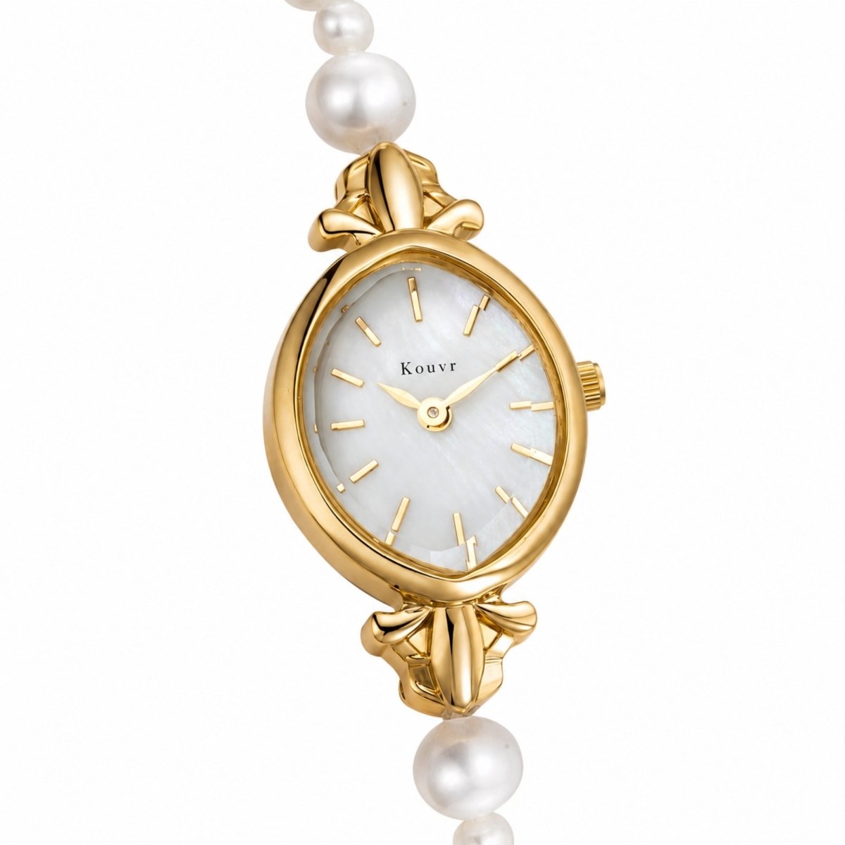 Angled close-up of the Kouvr gold-tone stainless steel watch case highlighting the pristine dial and elegant pearl band connection.