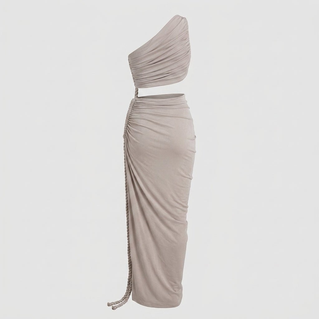 Angled view of a draped grey evening gown with high side slit and rope accent on a light grey background.
