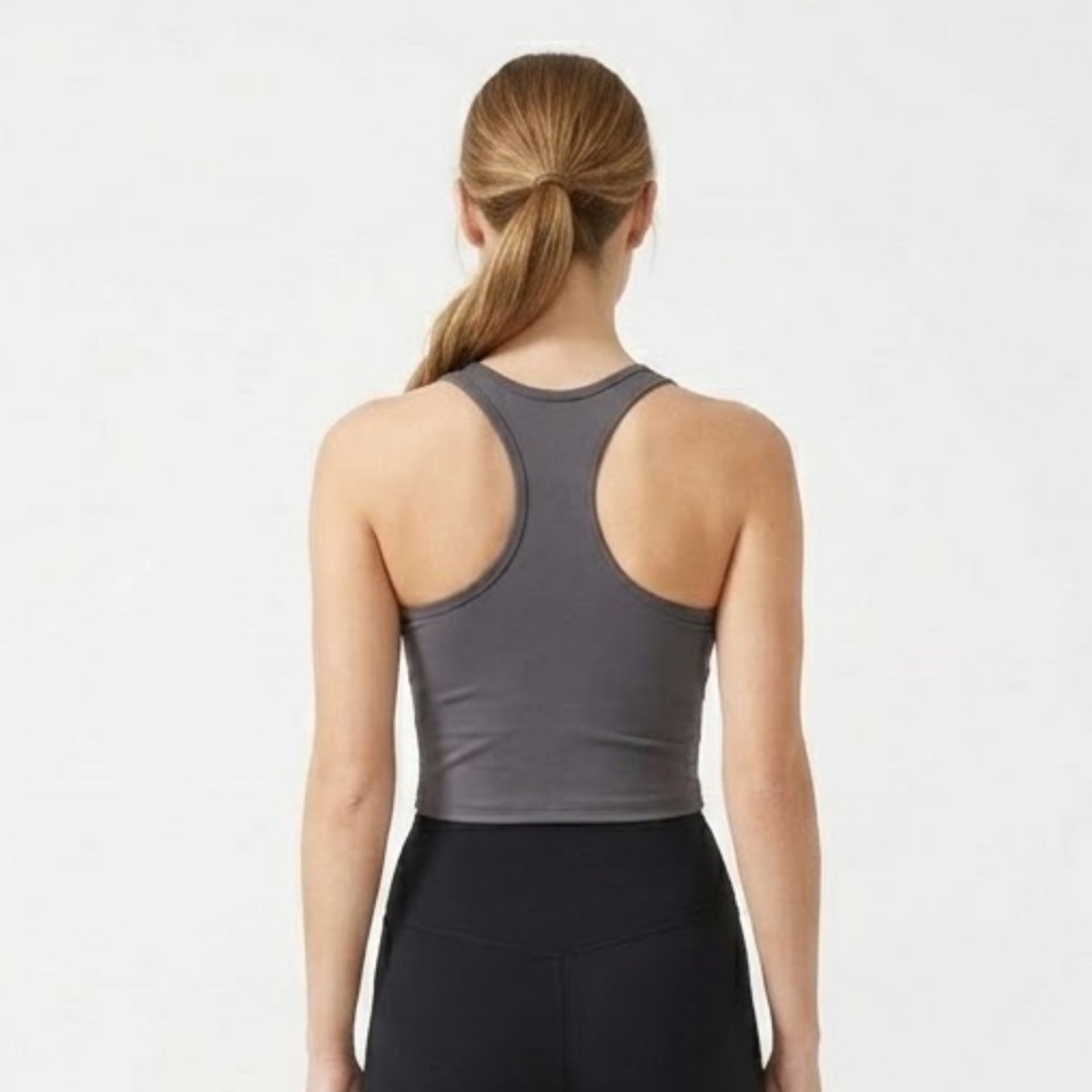 Back view of women's charcoal grey racerback sports bra showing T-back design.