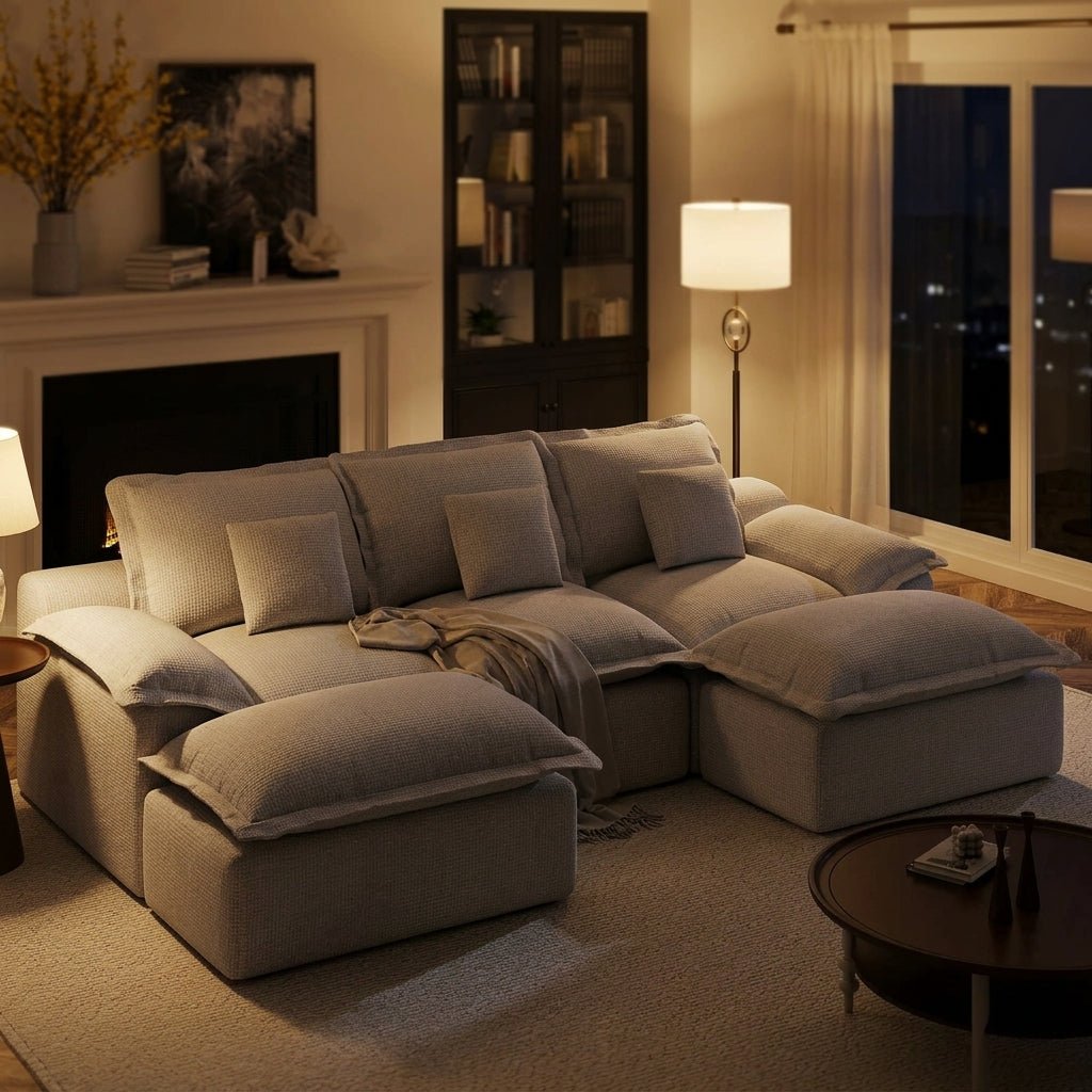 Symmetrical grey sectional sofa contrasted against dark charcoal walls in a minimalist, high-end living room.