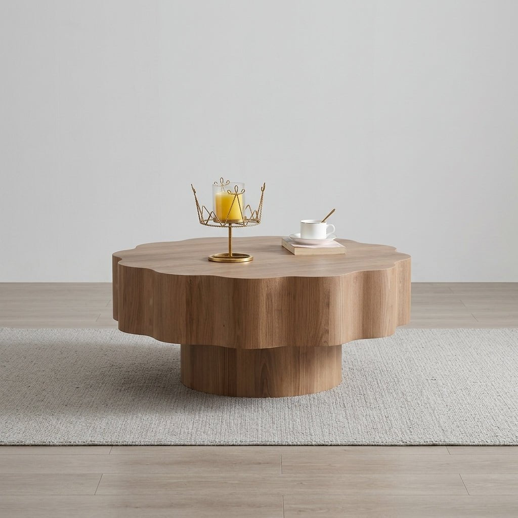 Close up detail of the smooth wavy scalloped edge and rich natural wood grain finish on the Japandi style pedestal coffee table.