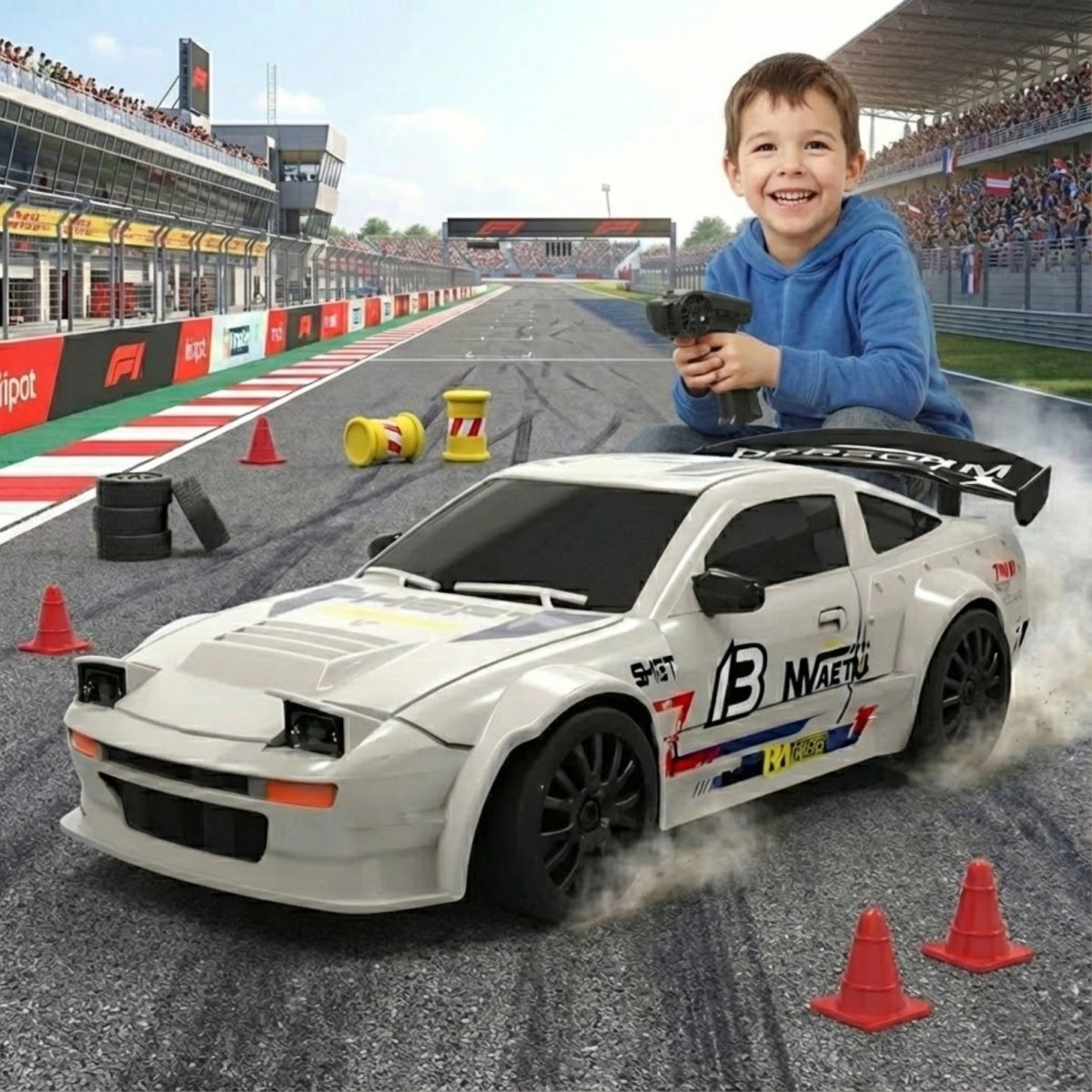 A young boy holding a remote control, smiling next to a white drift RC car that is on a race track with cones and tires.